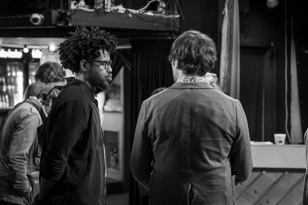 Black and white photo of Terrance in a scene, facing a partner whose back is to the camera