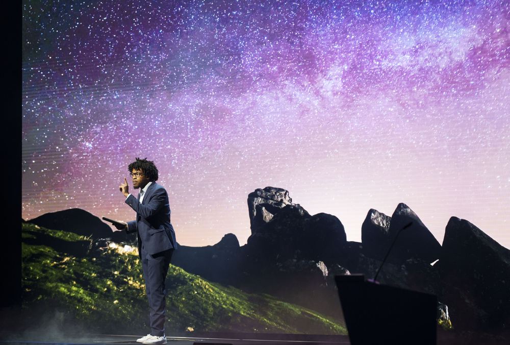 Terrance on a large stage in front of a starry night-sky backdrop