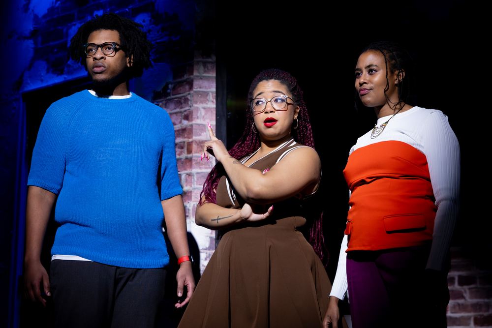 Terrance in a blue sweater in a scene with two castmates at The Second City